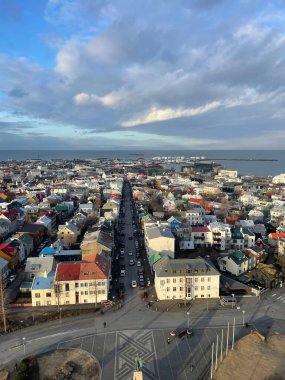 An aerial view of cityscape Reykjavik surrounded by buildings clipart