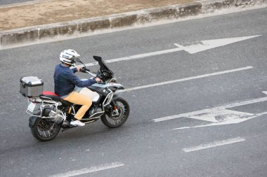 Lizbon sokaklarında BMW R1250 motosiklet kullanan bir motosikletli.