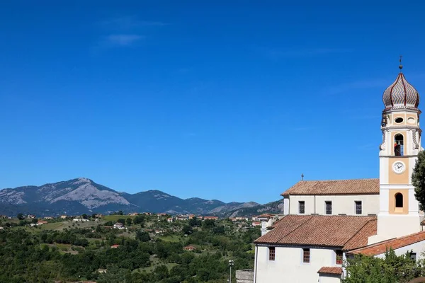 stock image An aerial shot of lush scenery and the Church of Saint James against the blue sky in Lauria, Italy