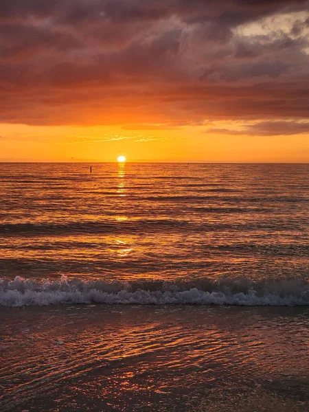 Eine Vertikale Aufnahme Eines Bewölkten Sonnenuntergangs Über Dem Meer — Stockfoto