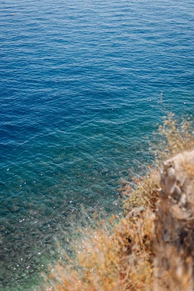 A vertical selective focus of the blue waves of the sea, can be used for wallpaper