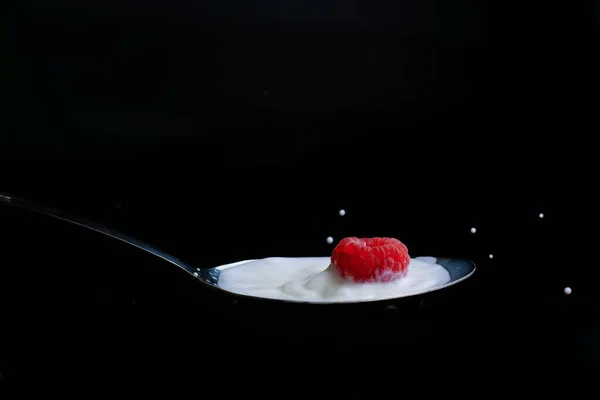 Raspberry Splashing Milk Metal Spoon Splash Effect Black Background — Stock Photo, Image