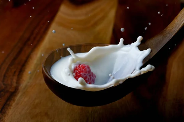 Fresh Raspberry Splashing Milk Wooden Spoon Splash Effect Black Background — Stock Photo, Image