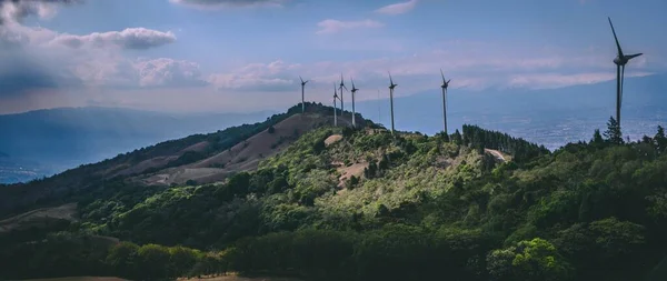 stock image A panoramic shot of the Valle wind farm Central Park surrounded by green mountains in the daytime