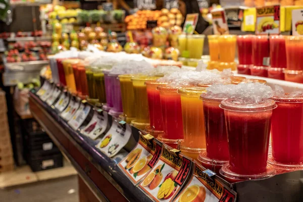 西班牙市场的塑料容器中精选美味的新鲜果汁 — 图库照片