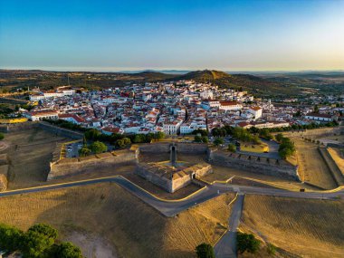 A drone shot of the Elvas castle in Portugal with residential buildings on its background clipart