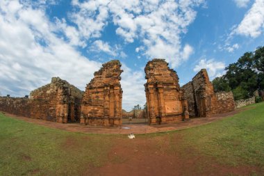 San Ignacio 'daki Ruinas de San Ignacio Mini, Misiones, Arjantin' de bulutlu gökyüzünün altındaki ağaçlarla
