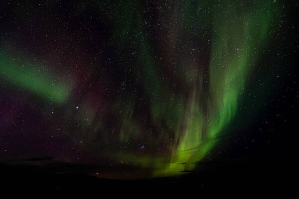 A beautiful shot of polar lights against a dark starry night sky