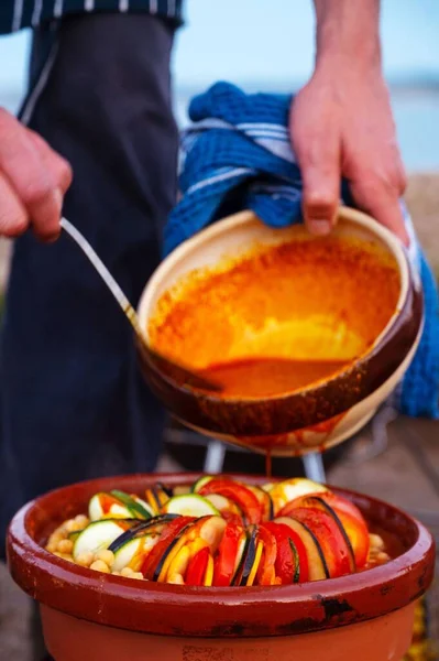 Vertical Shot Person Adding Sauce Ratatouille Dish Large Bowl — Stock Photo, Image