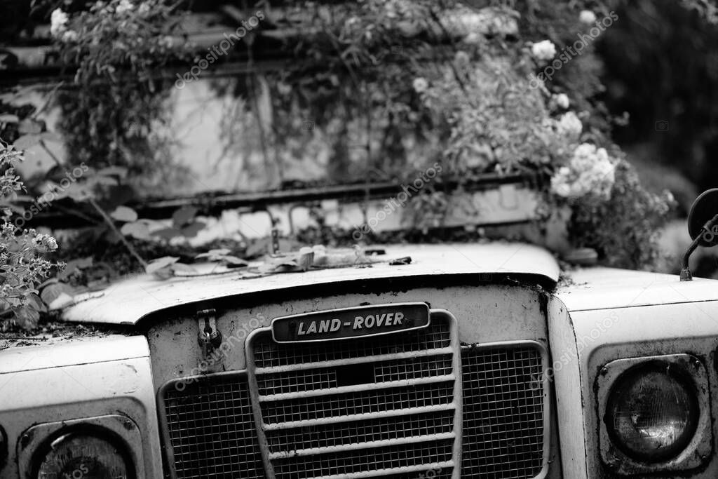 Manchester UK Dec 2022 old damaged Land rover 4 x 4 off road vehicle rotting away showing badge grill and bonnet