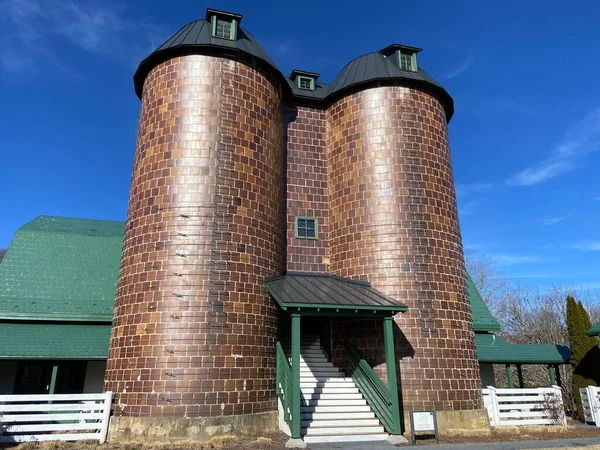 An exterior view of an old rural tower tank with brick walls in sunny weather in Virginia