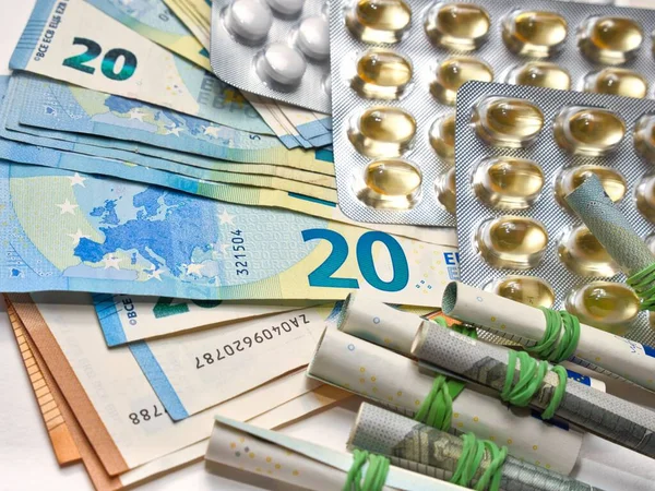 stock image A Medication in a pack lying on a pile of euro bills