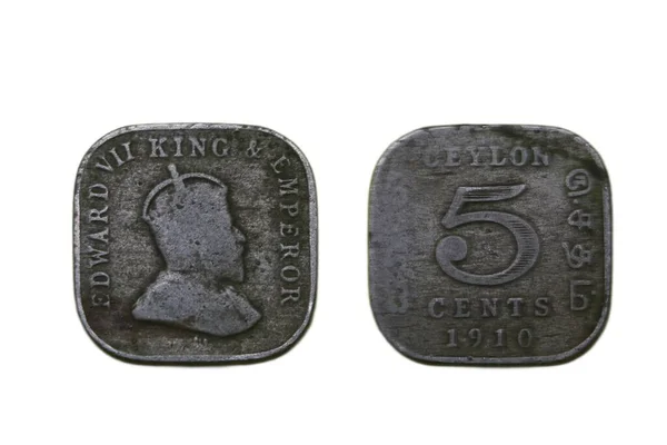 A closeup shot of a Sri Lankan or Ceylonian five cents coin made in 1910, from a front side and a back side view, isolated on a white background