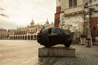 Eros Bendato heykeli, arka planda şehir, Krakow, Polonya