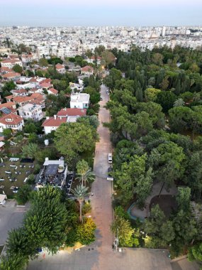 A beautiful view of a residential area and park with green trees in Antalya, Turkey clipart