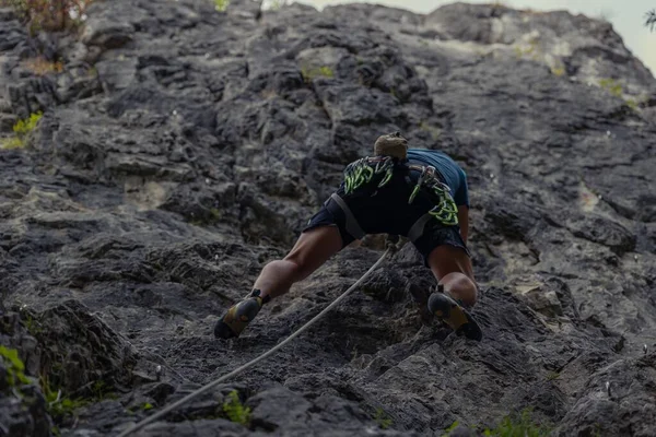 The man climbing the cliff. Rock climbing, sport concept.