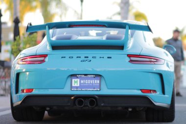 Açık mavi Porsche 'nin arkası gündüz vakti bir araba fuarında.