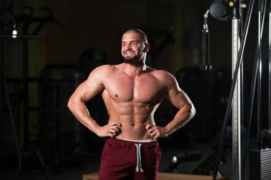 Spor salonundaki egzersizden sonra vücudunu gösteren çekici bir fitness modelinin portresi.