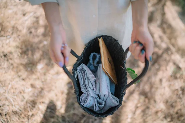 stock image A top view of a girl showing the inside of her bag with clothes and a notebook