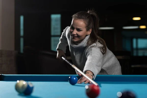 stock image A closeup of a young woman playing billiards.