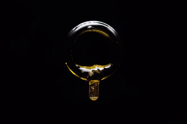 Närbild Droppande Honung Från Flaska Med Svart Bakgrund — Stockfoto