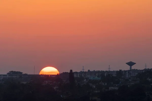 街の影とオレンジの色の美しい景色の明るい夕日 — ストック写真