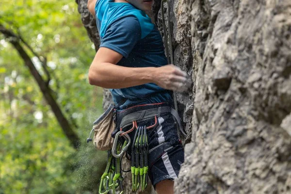 A young man climbing the cliff. Rock climbing, sport concept.