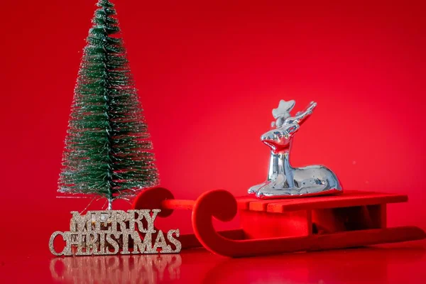 Closeup Miniature Decorative Reindeer Slay Next Christmas Tree Red Background — Stock Photo, Image