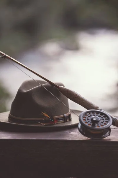 帽子の縦型クローズアップショットと隔離された背景に対する釣りのタックル — ストック写真