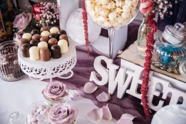 Decorated table with sweets and flowers