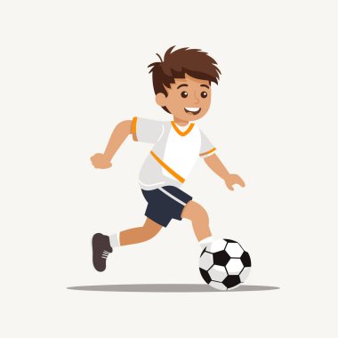 Çocuk futbol topunu tekmelerken koşuyor.