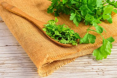 Fresh herbs on wooden spoon