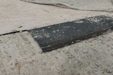 Closeup view of asphalt patch on rough surface