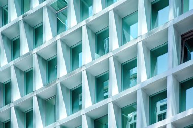 Modern building facade featuring geometric patterns and glass windows