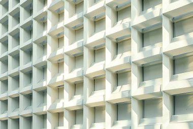 Textured wall featuring multiple square openings and shadows