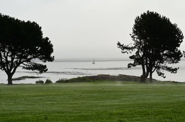 Steep Coastal Cliff Face Rising from the Clear Blue Sea
