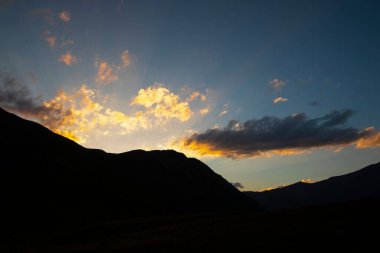 Mountain Silhouettes Against a Dramatic Sky at Sunset or Sunrise