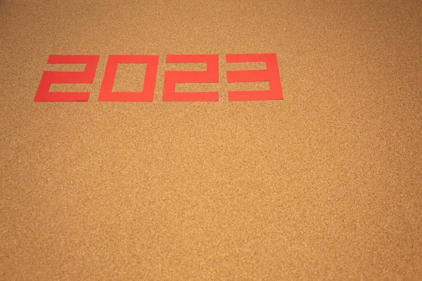 A blank cork board with the number 2023 on it with copy space