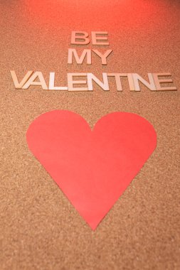 A Valentine's cork card with a red heart. Be my Valentine.
