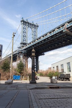 Manhattan Bridge seen from the ground on a warm day