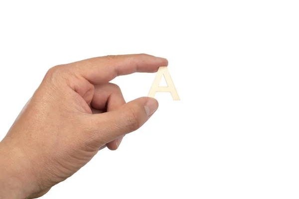 Close Mão Uma Pessoa Segurando Uma Pequena Letra Madeira Isolado — Fotografia de Stock