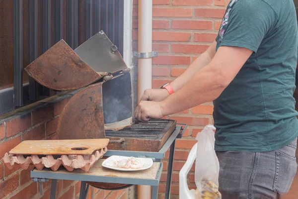 一个无法辨认的人点燃了一个手艺人烤架的炉火 — 图库照片