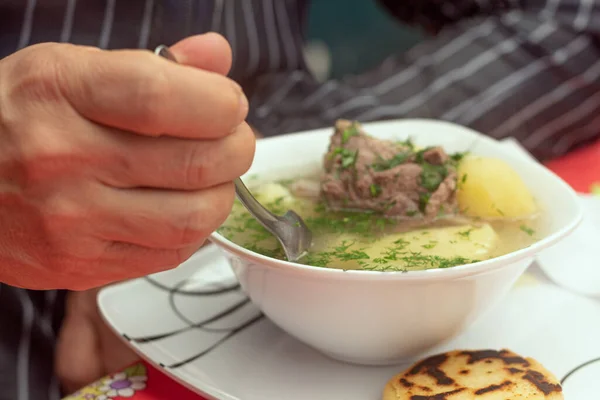 Close Man Hand Eating Bowl Soup Meat Broth Cilantro Potato Stock Image