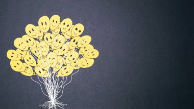 Many tender yellow balloons with smile on black background. Yellow day concept. Balloon tree, handmade.  Image with space for text. clipart