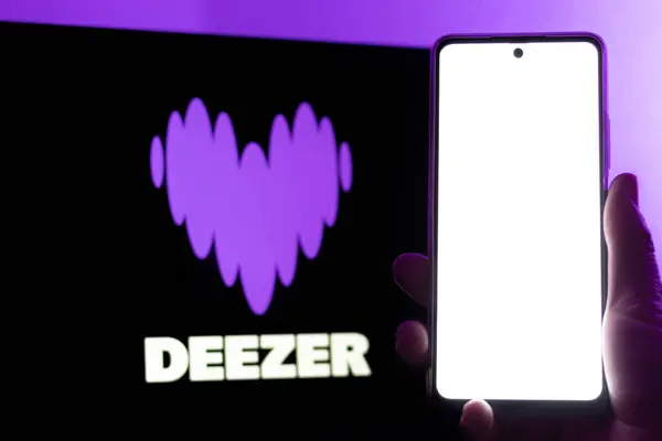 stock image Bogota, Colombia - July 12, 2024: Smartphone in portrait with blank screen. Deezer logo in the background. Music and podcast streaming platform.