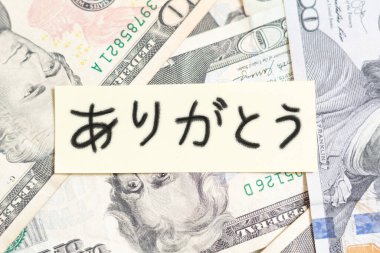 Handwritten thank you note in Japanese on American banknotes. Thank you for the money clipart