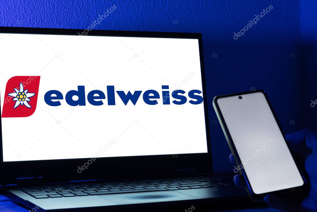 Bogota, Colombia - May 14, 2025: Laptop showing the logo of Edelweiss Air, Swiss airline, in front a person using a cell phone. Concept of European tourism