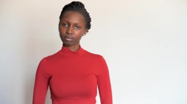 Genç bir kadın kameraya bakıyor..