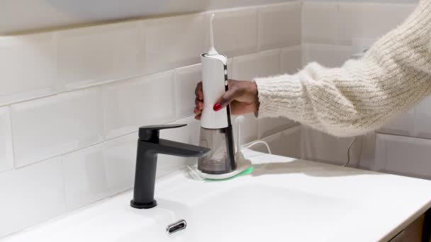 Effortless Oral Health Woman Filling Water Flosser Tank Bathroom Basin — Video Stock