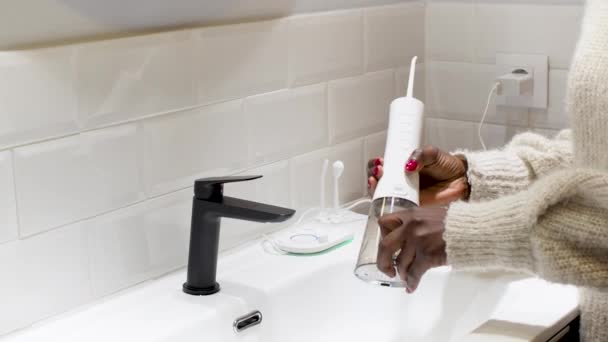 Effortless Oral Health Woman Filling Water Flosser Tank Bathroom Basin — Stockvideo